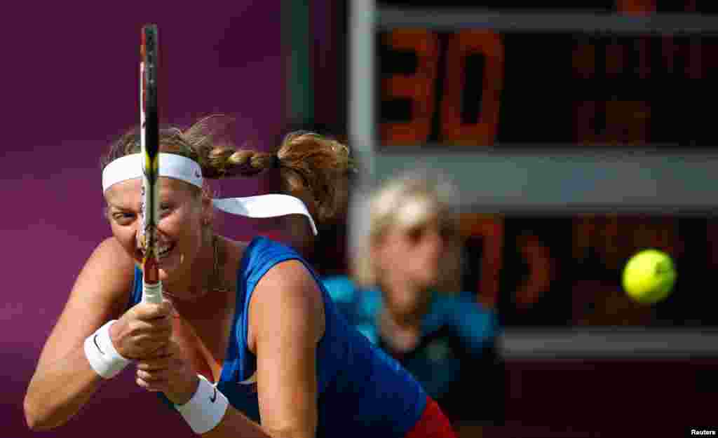 Czech Republic's Kvitova returns to China's Peng in their women's singles tennis match at the All England Lawn Tennis Club.