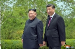 FILE - Chinese President Xi Jinping and North Korean leader Kim Jong Un walk during Xi's visit in Pyongyang, North Korea, in this picture released by North Korea's Korean Central News Agency (KCNA), June 21, 2019.