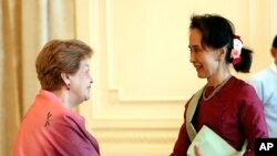 Myanmar's leader Aung San Suu Kyi, right, shakes hands with Philippine diplomat Rosario Manalo, a member of the Independent Commission of Enquiry for Rakhine State, at the Presidential Palace in Naypyitaw, Myanmar, Jan. 20, 2020.