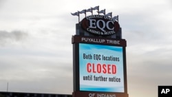 A sign indicates that the new Emerald Queen Casino in Tacoma, Wash., which is owned by the Puyallup Tribe of Indians, is closed, April 30, 2020. 