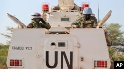 FILE - U.N. peacekeepers in an armored personnel carrier lead a patrol from Bentiu toward the village of Nhialdiu, South Sudan, Dec. 7, 2018.