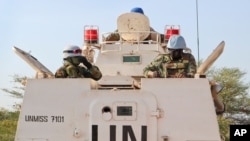 FILE - U.N. peacekeepers in an armored personnel carrier lead a patrol from Bentiu toward the village of Nhialdiu, South Sudan, Dec. 7, 2018.