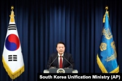 In this photo provided by South Korea Presidential Office, South Korean President Yoon Suk Yeol speaks during a press briefing at the presidential office in Seoul, South Korea, Tuesday, Dec. 3, 2024. (South Korea Unification Ministry via AP)