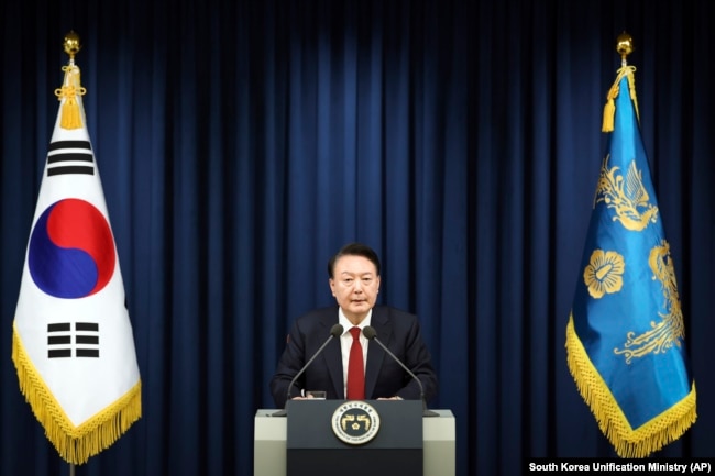 In this photo provided by South Korea Presidential Office, South Korean President Yoon Suk Yeol speaks during a press briefing at the presidential office in Seoul, South Korea, Tuesday, Dec. 3, 2024. (South Korea Unification Ministry via AP)