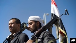 Houthi Shiite Yemenis hold their weapons during a rally to show support for their comrades in Sanaa, Yemen, Feb. 4, 2015.