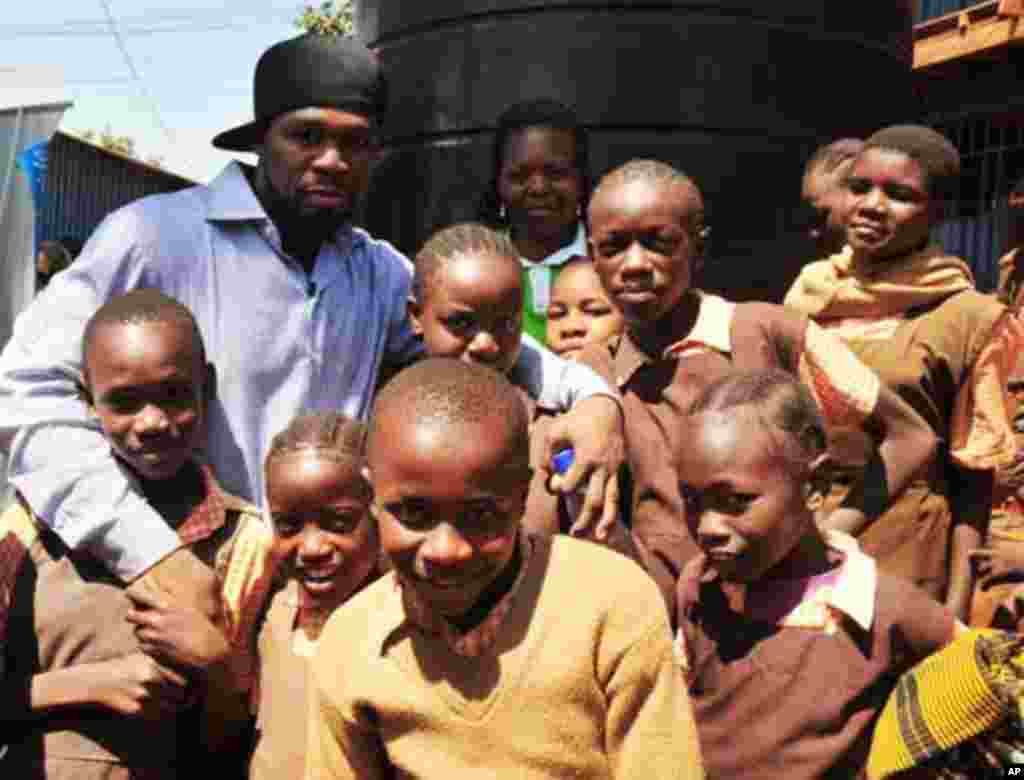 Rap artist and actor 50 Cent mingles with children from a school in Kibera slums in Kenya's capital Nairobi February 9, 2012.