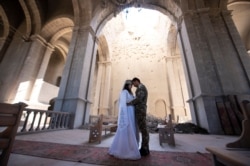 Nagorno-Karabakh natives Hovhannes Hovsepyan and Mariam Sargsyan take part in a wedding ceremony at the Ghazanchetsots Cathedral in the town of Shushi (Shusha), Oct. 24, 2020. (David Ghahramanyan/NKR InfoCenter/PAN Photo via Reuters)