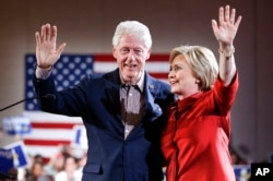 Democratic presidential candidate Hillary Clinton, right, waves on stage with husband and former President Bill Clinton for a Nevada Democratic caucus rally, in Las Vegas, Feb. 20, 2016.