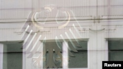 FILE - A general view shows a federal eagle reflected in a window in front of a building in the north part of the compound of the German Federal Intelligence Agency (BND) in Berlin.