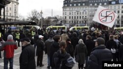 Counter-demonstrators gather to show their disapproval of a movement calling itself "The People's Demonstration", which held a meeting and demonstration at Norrmalmstorg square in Stockholm, Sweden, Jan.30, 2016. 