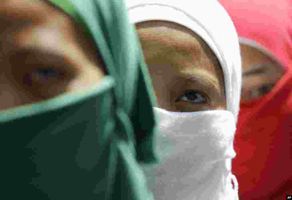 Filipino Muslim women join a rally outside the Office of the Presidential Adviser on the Peace Process in suburban Pasig, east of Manila, Philippines.