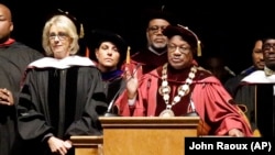 Bethune-Cookman University president Edison Jackson, right, appeals to protesters disrupting Education Secretary Betsy DeVos' speech during commencement exercises, Wednesday, May 10, 2017, in Daytona Beach, Florida.