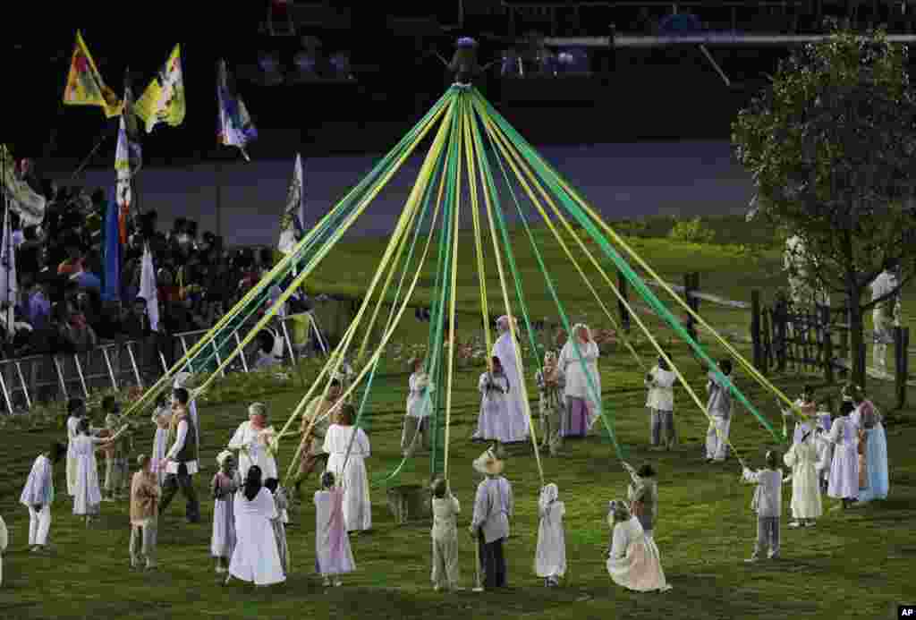 Performers make a circle during the Opening Ceremony at the 2012 Summer Olympics, July 27, 2012, in London.