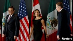 FILE - From left, Mexico's Economy Minister Ildefonso Guajardo, Canada's Foreign Minister Chrystia Freeland and U.S. Trade Representative Robert Lighthizer arrive for a meeting during the third round of NAFTA talks involving the United States, Mexico and Canada in Ottawa, Ontario, Sept. 27, 2017.