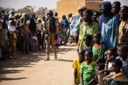 FILE - A Burkina Faso soldier patrols at district welcoming internally displaced people from northern Burkina Faso in Dori, Feb. 3, 2020.