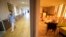 FILE - A nurse walks in a corridor of a nursing home as a resident sits in a chapel during COVID-19 testing in Bergheim, eastern France. 