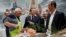 French President Emmanuel Macron visits the French fishing stand during the 57th International Agriculture Fair (Salon de l'Agriculture) at the Porte de Versailles exhibition center in Paris, France, Feb. 22, 2020.