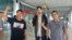 American journalist Philip Myrer Jacobson, center, poses with his Indonesian lawyers at Cilik Riwut Airport in Palangkaraya, Indonesia, Jan. 31, 2020.