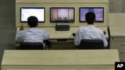 North Korean technicians man computer terminals at North Korea's space agency's General Launch Command Center on the outskirts of Pyongyang, April 11, 2012.