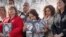 Rosie Cortinas (C) holding a photo of her son, Amador Cortinas, of Idaho, who was killed last year while driving a Chevy Cobalt, joins other families whose loved ones died behind the wheel of defective General Motors cars, in Washington, April 1, 2014.