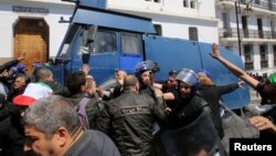 Police officers disperse people protesting after parliament appointed upper house chairman Abdelkader Bensalah as interim president following the resignation of Abdelaziz Bouteflika in Algiers, Algeria, April 9, 2019. 