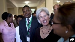 U.S. Secretary of Health and Human Services Kathleen Sebelius, center, talks to a health worker during a visit to Eliazar Germain hospital in Port-au-Prince, Haiti, April 16, 2012.