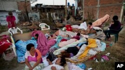 Four families wake up after sleeping outside their homes that collapsed during the earthquake in Manta, Ecuador, Tuesday, April 19, 2016. The strongest earthquake to hit Ecuador in decades flattened buildings and buckled highways along its Pacific coast, sending the Andean nation into a state of emergency. 
