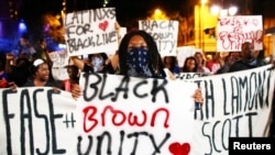 Protesters march in the streets during another night of protests over the police shooting of Keith Lamont Scott in Charlotte, North Carolina, Sept. 23, 2016.