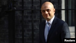 Britain's Home Secretary Sajid Javid arrives in Downing Street in London, May 1, 2018. Javid is to unveil Monday new security measures including the hiring of an extra 1,000 intelligence officers to help keep suspected extremists under better surveillance.