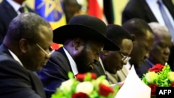 FILE - South Sudan President Salva Kiir signs a final power-sharing deal between South Sudanese arch-foes, in Khartoum, Aug. 5, 2018. Formation of a transitional government is expected to miss its May 12 deadline.
