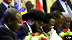 FILE - President of South Sudan Salva Kiir signs a final power-sharing deal between South Sudanese arch-foes in Khartoum, Sudan, 8.5.2018