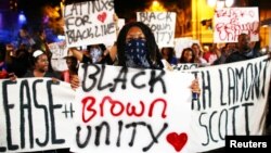 Protesters march in the streets during another night of protests over the police shooting of Keith Lamont Scott in Charlotte, North Carolina, Sept. 23, 2016.