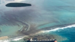 This photo taken and provided by Eric Villars shows oil leaking from the MV Wakashio, a bulk carrier ship that recently ran aground off the southeast coast of Mauritius, Aug. 7, 2020.