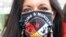 FILE - Jeannie Hovland, the deputy assistant secretary for Native American Affairs for the U.S. Department of Health and Human Services, poses with a Missing and Murdered Indigenous Women mask, Wednesday, Aug. 26, 2020, in Anchorage, Alaska.