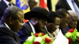 FILE - South Sudan President Salva Kiir signs a final power-sharing deal between South Sudanese arch-foes, in Khartoum, Aug. 5, 2018. Formation of a transitional government is expected to miss its May 12 deadline.