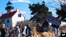 Volunteers hold a "Save The Lighthouse" rally near the East Point Lighthouse in Maurice River Township, N.J., Nov. 10, 2018. 
