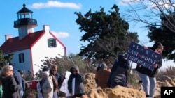 Volunteers hold a "Save The Lighthouse" rally near the East Point Lighthouse in Maurice River Township, N.J., Nov. 10, 2018. 