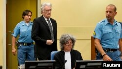 FILE - Bosnian Serb wartime leader Radovan Karadzic appears in the courtroom for his appeals judgement at the International Criminal Tribunal for Former Yugoslavia at The Hague.