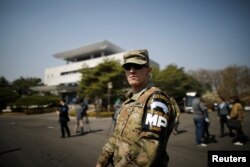 A U.S. Army soldier stands guard in front of the Peace House at the truce village of Panmunjom inside the demilitarized zone separating the two Koreas, South Korea, April 18, 2018.