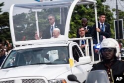 Pope Francis greets well-wishers after arriving in Kinshasa, Congo, Tuesday Jan. 31, 2023. (AP Photo/Samy Ntumba Shambuyi)