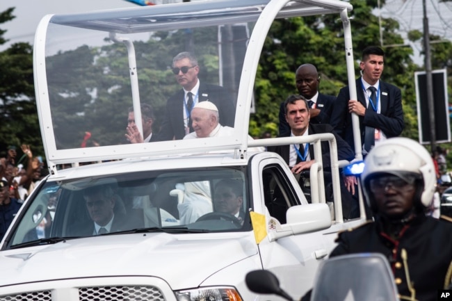 Pope Francis greets well-wishers after arriving in Kinshasa, Congo, Tuesday Jan. 31, 2023. (AP Photo/Samy Ntumba Shambuyi)