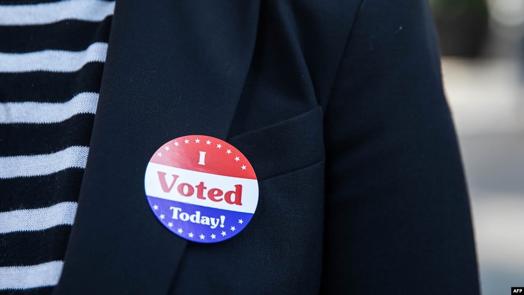 Lisa O. wears an "I Voted Today!" sticker after casting her vote during early voting at City Hall in Philadelphia, Pennsylvania on October 7, 2020. (Photo by GABRIELLA AUDI / AFP)