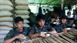 Members of the PDF eat at their camp