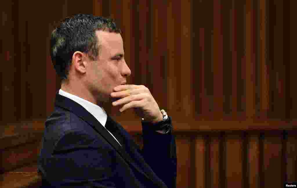 Oscar Pistorius sits in the dock during his murder trial in the North Gauteng High Court in Pretoria, June 30, 2014.