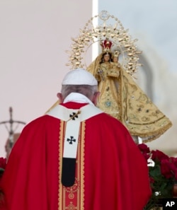 Pope Francis prays before a statue of the Virgin of Charity, Cuba's patron saint, as he arrives to celebrate a Mass at the Plaza of the Revolution, in Holguin, Cuba, Sept. 21, 2015.