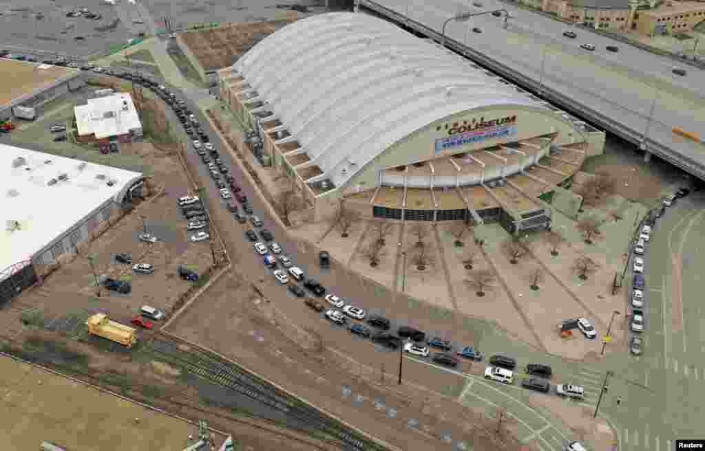 Cars are lined up outside the Denver Coliseum as people wait to be tested for coronavirus disease (COVID-19) at a drive-thru testing station in Denver, Colorado, March 14, 2020.