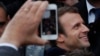French independent centrist presidential candidate Emmanuel Macron shakes hands with well-wishers as he leaves the polling station after casting his ballot in the presidential runoff election in Le Touquet, France, May 7, 2017. 