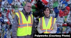 Paul Tasner and Elena Olivari talk to investors standing in front of a mountain of plastic trash.