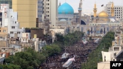 A handout picture provided by the Iranian presidency on May 23, 2024, shows Iranian mourners attending the funeral of late president Ebrahim Raisi in the city of Mashhad