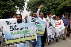 Demonstrators hold signs and chant slogans as they march in solidarity with the people of Kashmir, during a rally in Karachi, Pakistan, Aug. 5, 2019.